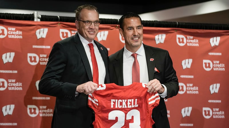 Wisconsin athletic director Chris McIntosh, left, introduces new head football coach Luke...