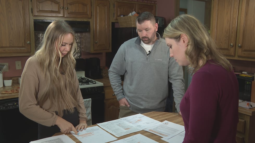 Josie and Alex Schmidt explain the documents in front of the to 7 Investigates regarding the...