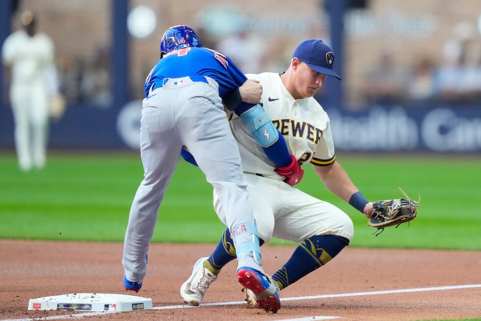 Chicago Cubs' Pete Crow-Armstrong, left, runs into Milwaukee Brewers first baseman Andrew...