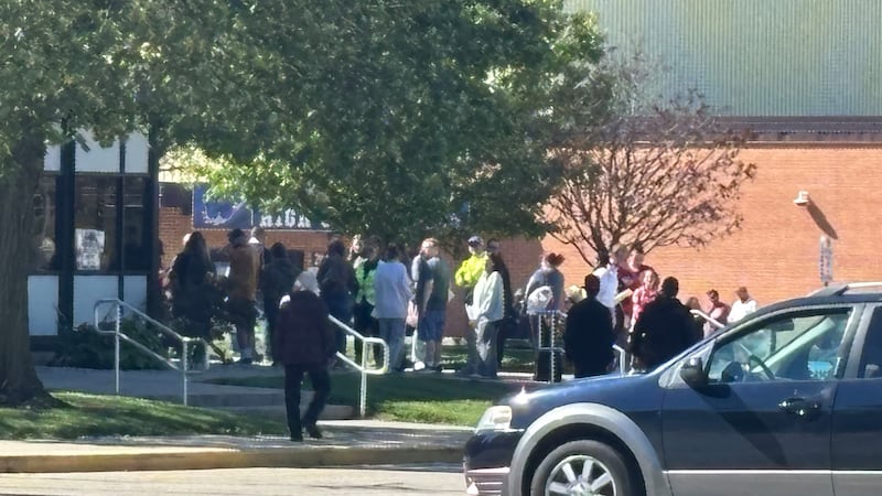 Parents of Oshkosh North students wait to be reunited at West High School after a weapons...