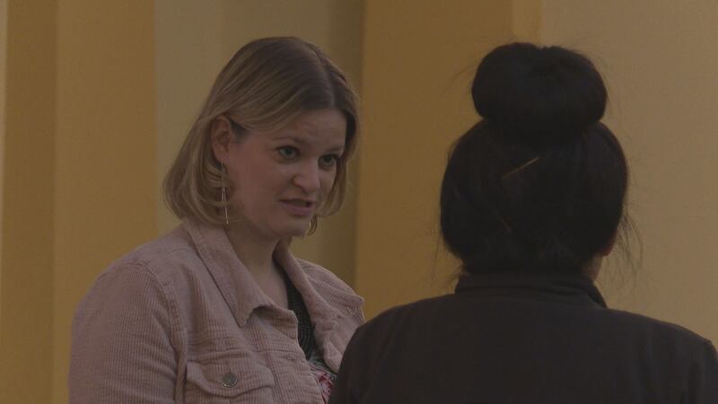 Representative Katrina Shankland speaks with an attendee at a round table discussion held at...