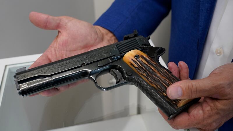 In this Aug. 25, 2021 file photo, Brian Witherell displays a Colt .45-caliber pistol that once...