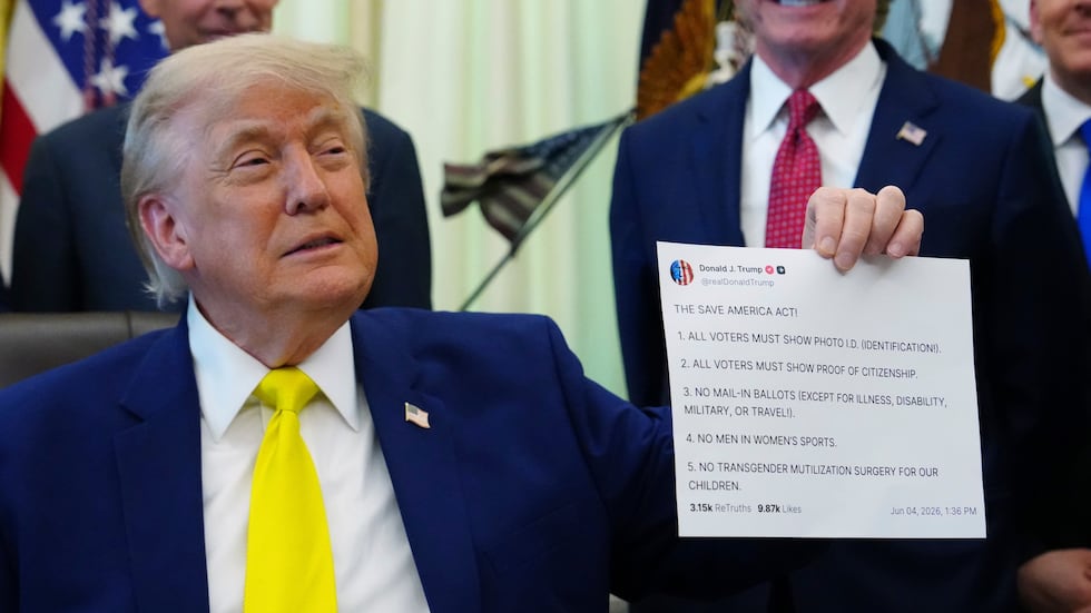 FILE - President Donald Trump holds up an image taken from his Truth Social account at an...