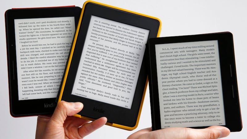 Amazon's Kindle Oasis, far right, the company's sleekest, lightest e-reader, which sells for...