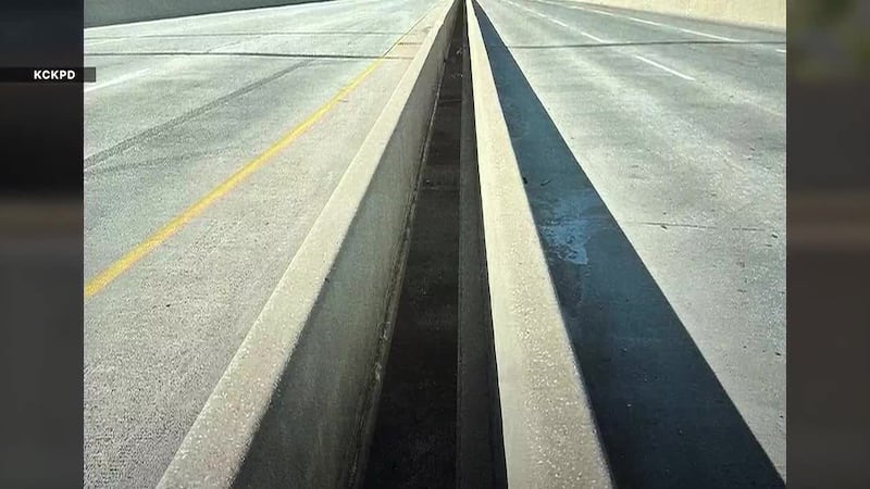 A Kansas mother of two died after falling 40 feet from a raised trafficway bridge.